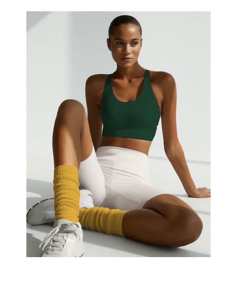 Woman in green top and yellow socks sitting relaxed after training